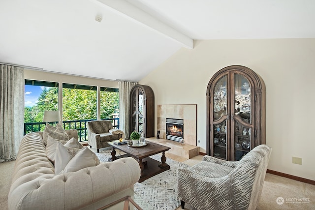 carpeted living room with a tile fireplace and lofted ceiling with beams