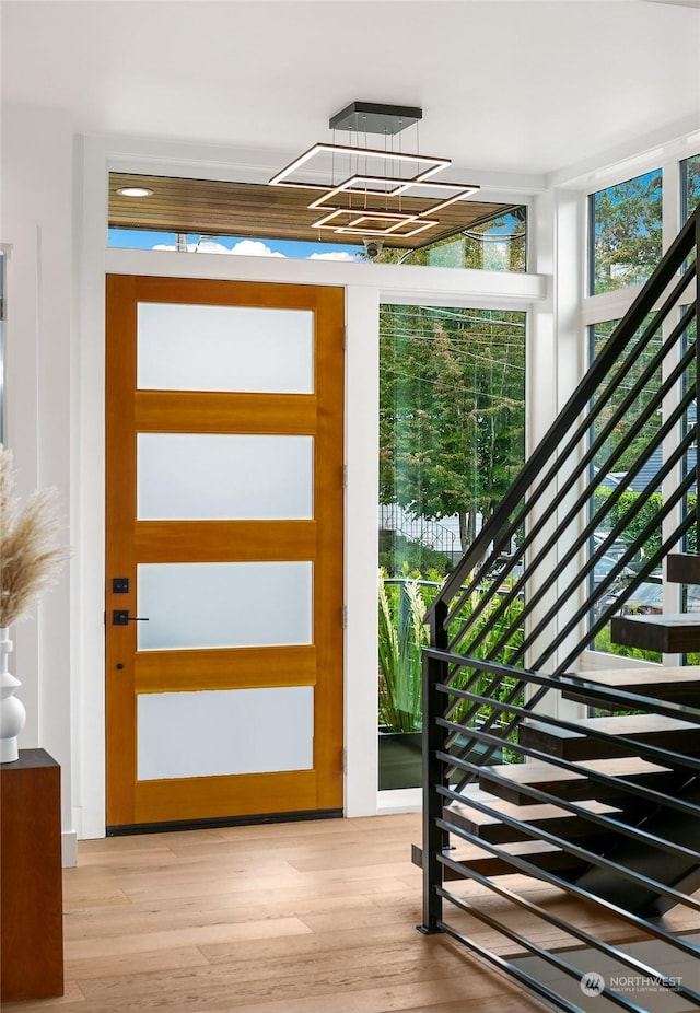 entryway featuring light wood-type flooring and stairway