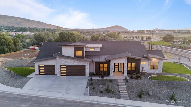 view of front of home featuring a garage and a mountain view