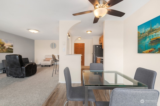 dining space with ceiling fan and hardwood / wood-style floors