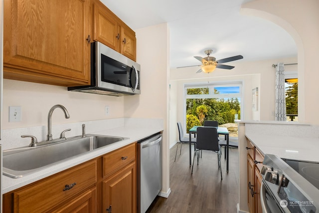 kitchen featuring dark hardwood / wood-style flooring, sink, appliances with stainless steel finishes, and ceiling fan