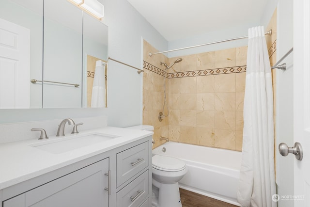 full bathroom with hardwood / wood-style flooring, vanity, shower / bath combo, and toilet