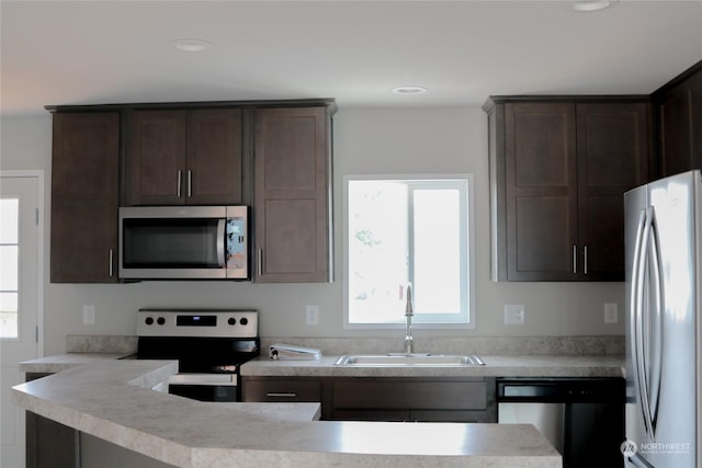 1400 Samuel Dr, Walla Walla, WA 99362 - kitchen with dark brown cabinets, a sink, light countertops, appliances with stainless steel finishes, and recessed lighting