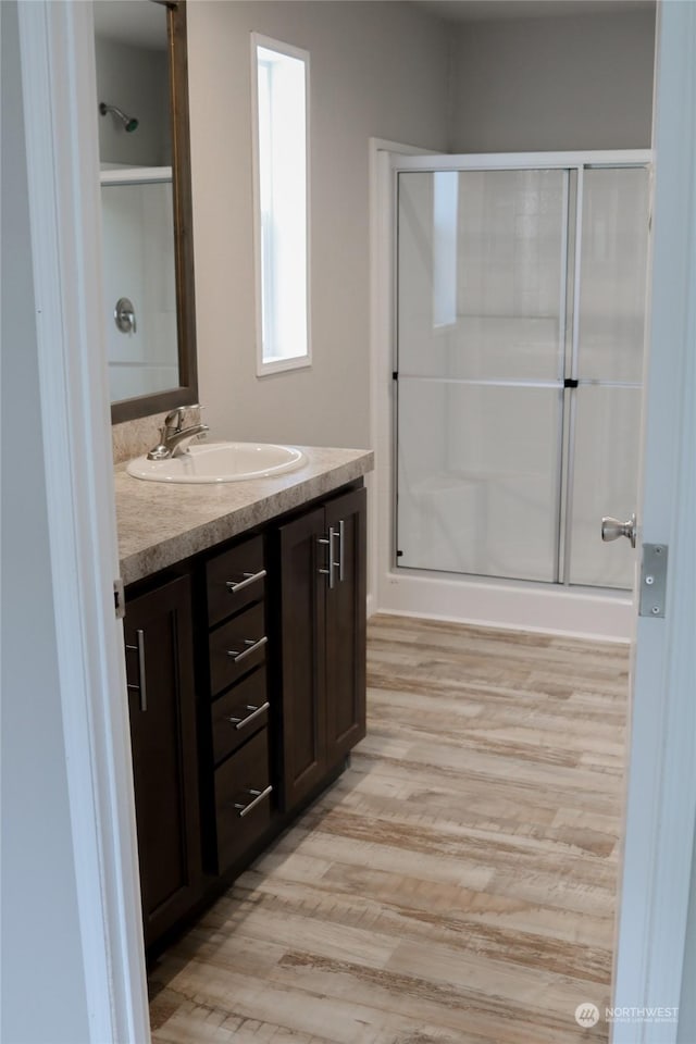 1400 Samuel Dr, Walla Walla, WA 99362 - bathroom with a shower stall, vanity, and wood finished floors