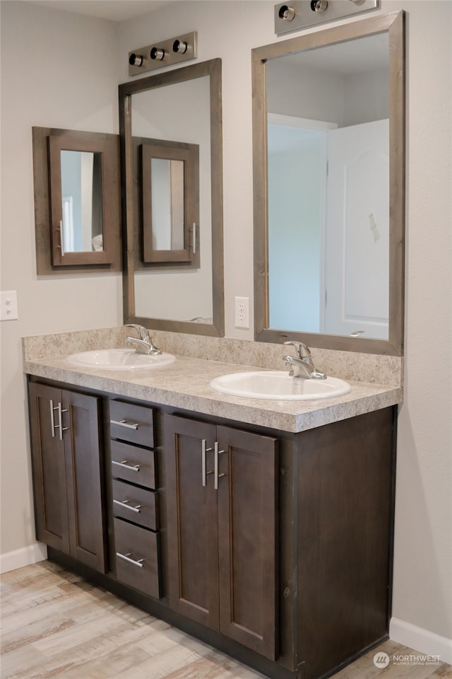 bathroom with wood-type flooring and vanity