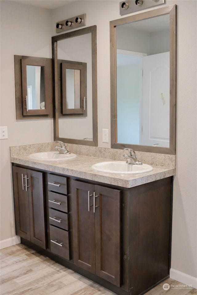 1400 Samuel Dr, Walla Walla, WA 99362 - bathroom with baseboards, double vanity, and a sink