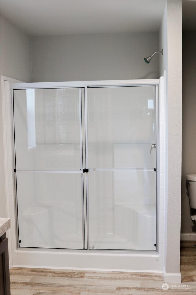 1400 Samuel Dr, Walla Walla, WA 99362 - bathroom with a stall shower, vanity, toilet, and wood finished floors