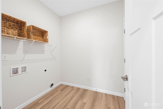 laundry area featuring hookup for a washing machine, laundry area, baseboards, light wood-style floors, and electric dryer hookup