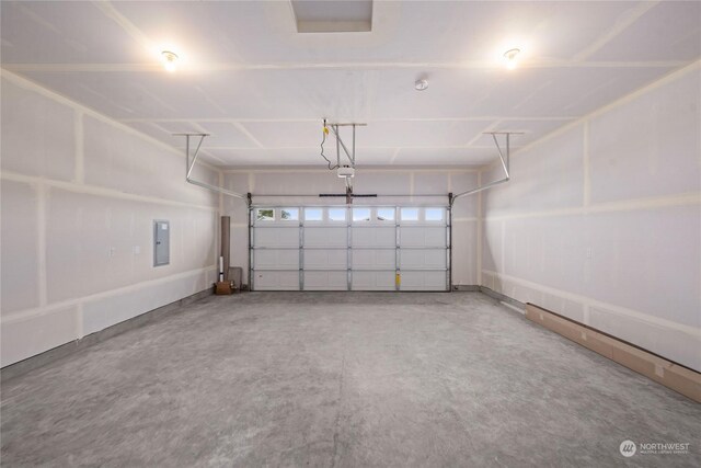 garage featuring a garage door opener and electric panel