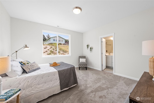 bedroom with light carpet and ensuite bath