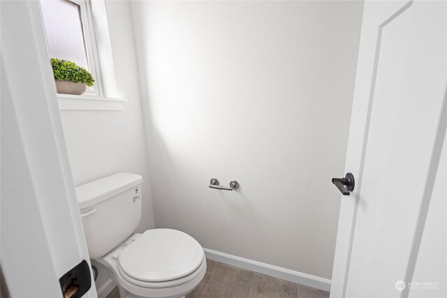 bathroom featuring toilet and tile patterned floors