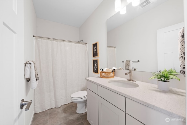 bathroom featuring a shower with shower curtain, tile patterned floors, toilet, and vanity