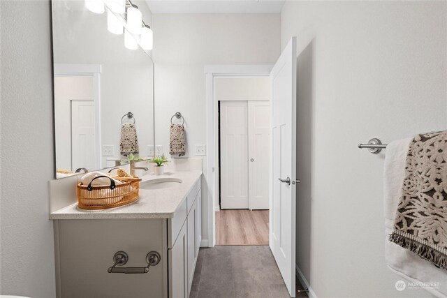 bathroom featuring hardwood / wood-style flooring and vanity