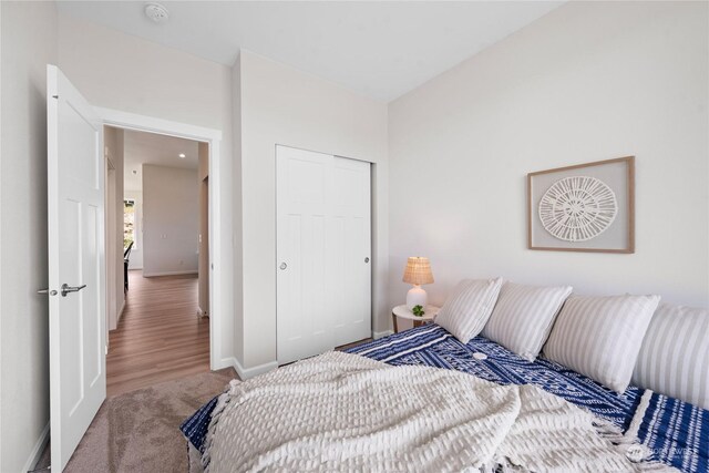 bedroom with a closet and hardwood / wood-style flooring