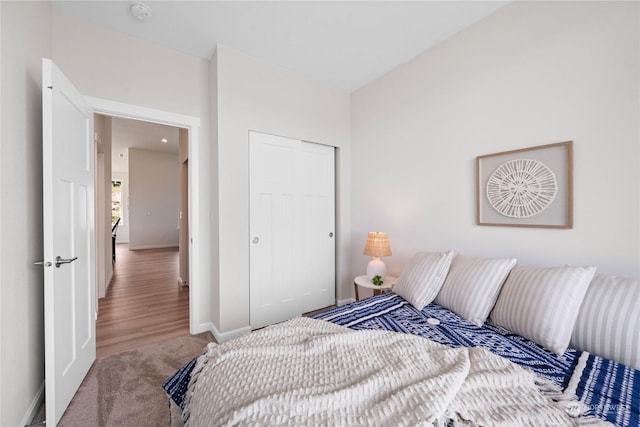 bedroom with carpet floors, a closet, and baseboards