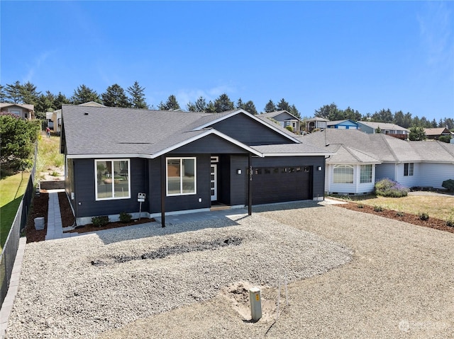 single story home with gravel driveway, roof with shingles, fence, and an attached garage