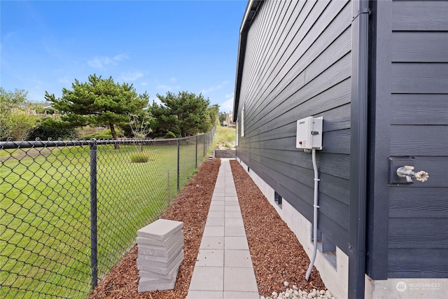 view of side of property featuring crawl space, fence, and a yard