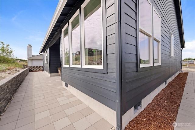 view of home's exterior featuring a patio and crawl space