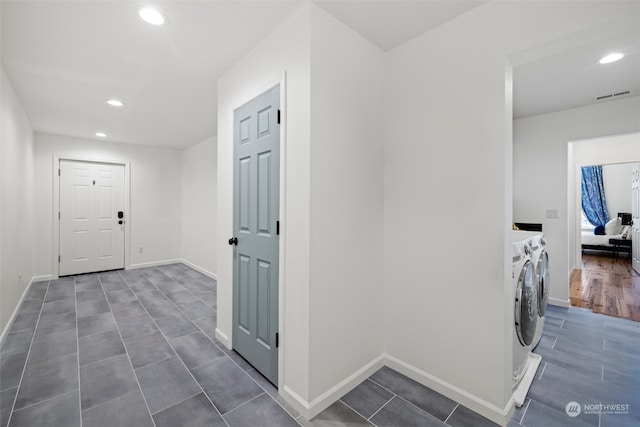 laundry area featuring washer and dryer and dark hardwood / wood-style floors