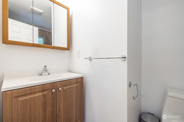 bathroom featuring vanity and toilet