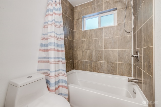 bathroom featuring shower / tub combo and toilet