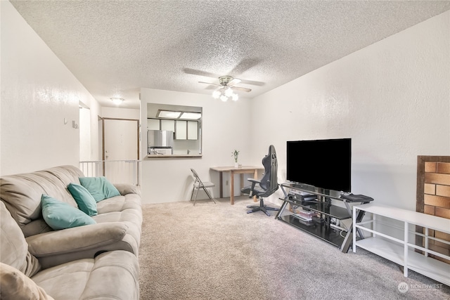 carpeted living area featuring a textured ceiling, a textured wall, and ceiling fan