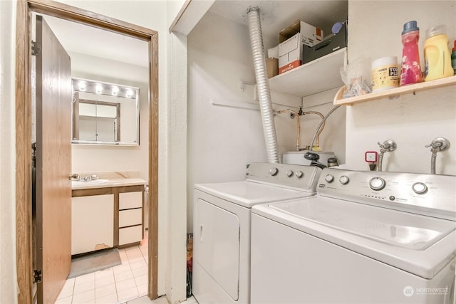 laundry room with laundry area, light tile patterned flooring, independent washer and dryer, and a sink