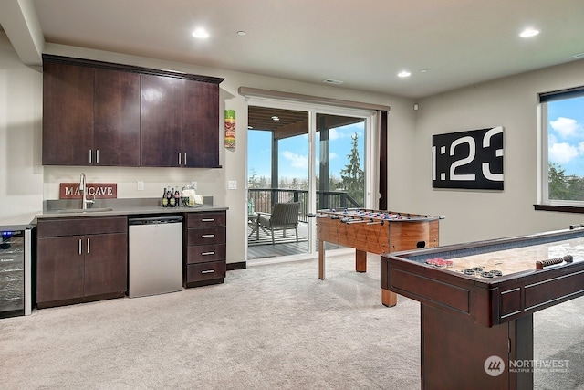 recreation room with light colored carpet, wine cooler, wet bar, and a healthy amount of sunlight