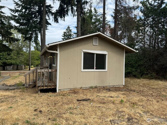 view of home's exterior with an outbuilding