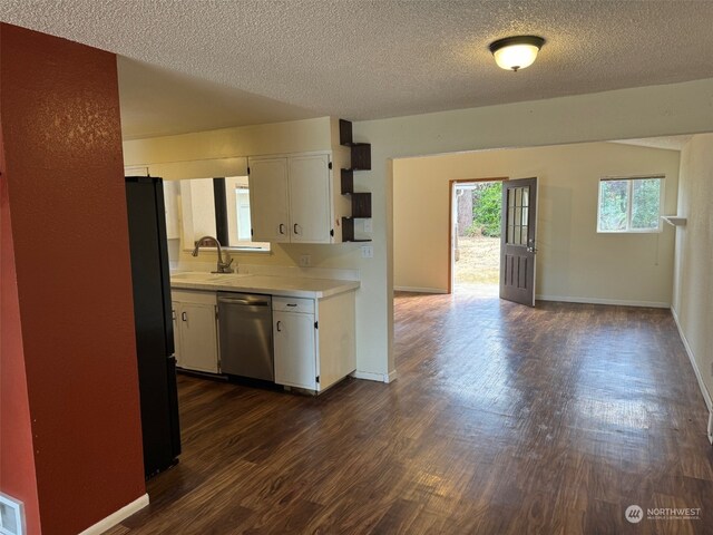 kitchen featuring sink, black fridge, dark wood-type flooring, dishwasher, and white cabinets