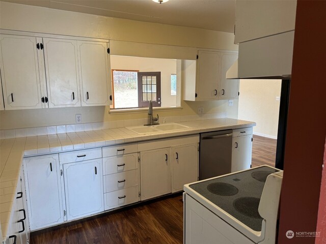 kitchen with stainless steel dishwasher, stove, dark wood-type flooring, and white cabinets