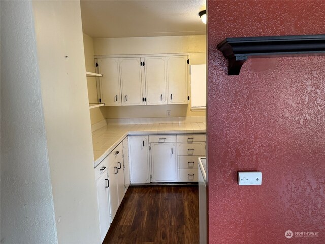 kitchen featuring tile countertops, white cabinetry, and dark hardwood / wood-style floors