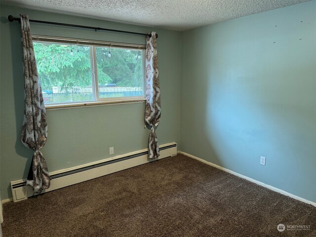 unfurnished room featuring a baseboard radiator, a textured ceiling, and carpet flooring