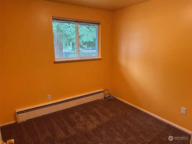 carpeted empty room with a baseboard radiator