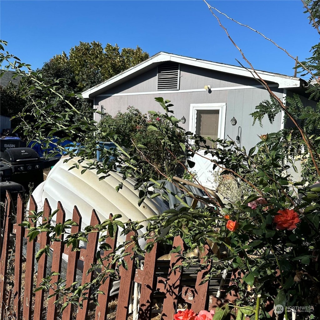 view of side of property featuring fence