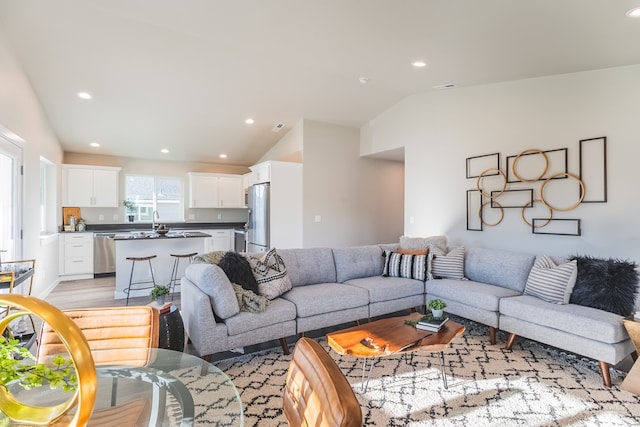 living room with light hardwood / wood-style floors and lofted ceiling