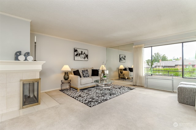 carpeted living room with a textured ceiling, a tile fireplace, and ornamental molding