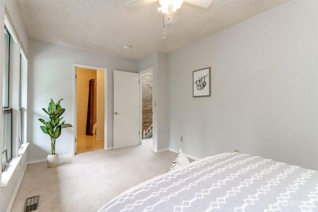 bedroom featuring a textured ceiling, carpet flooring, ceiling fan, and a closet