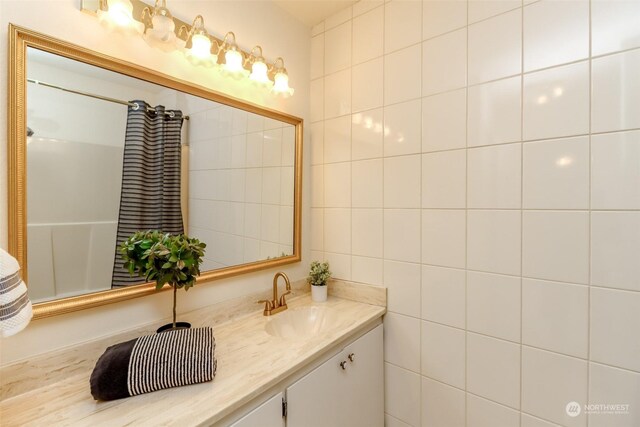 bathroom featuring tile walls and vanity