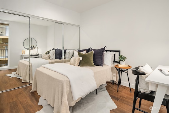 bedroom featuring a closet and dark hardwood / wood-style flooring