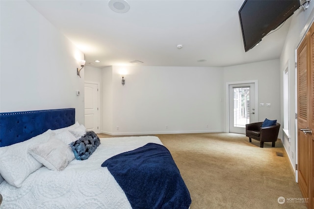 bedroom with light carpet and baseboards