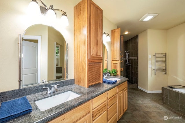 full bathroom with tile patterned flooring, double vanity, a sink, and walk in shower