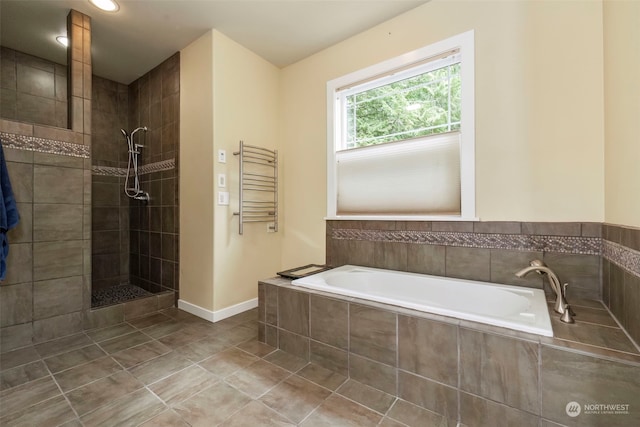 full bath featuring baseboards, radiator heating unit, a garden tub, tile patterned flooring, and walk in shower