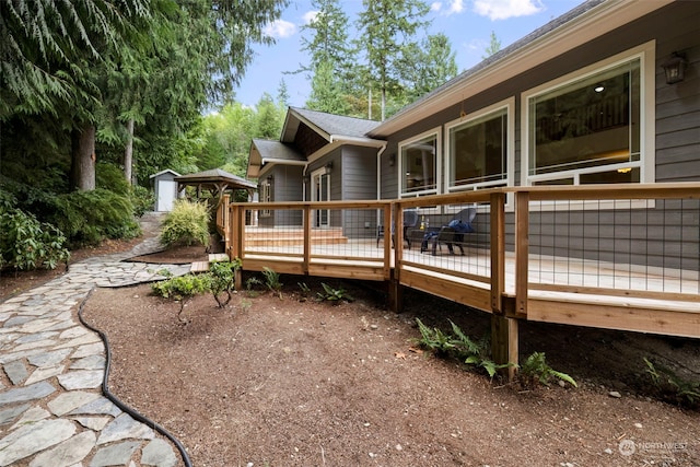 view of side of property with an outbuilding and a wooden deck