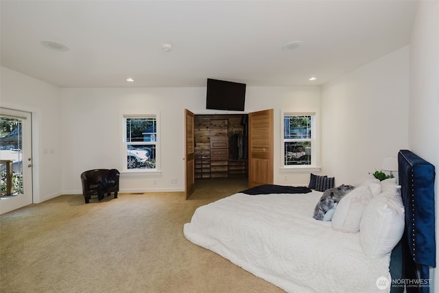 carpeted bedroom with recessed lighting, multiple windows, and baseboards