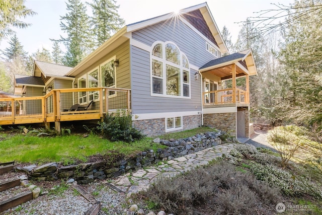 view of property exterior featuring a deck