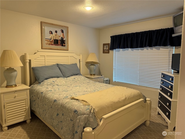 bedroom featuring dark colored carpet