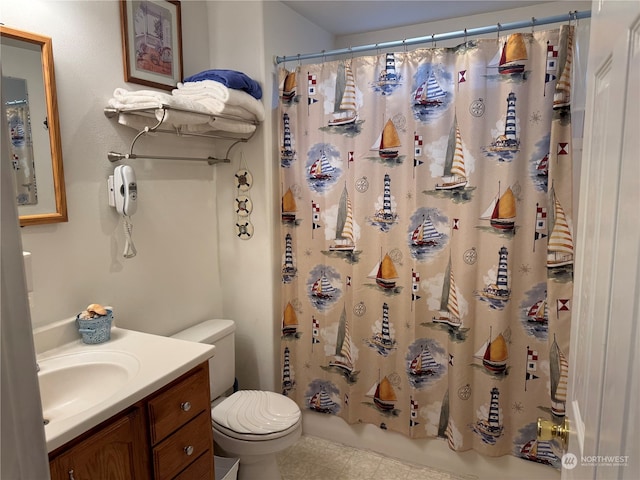 bathroom with tile patterned flooring, toilet, and vanity