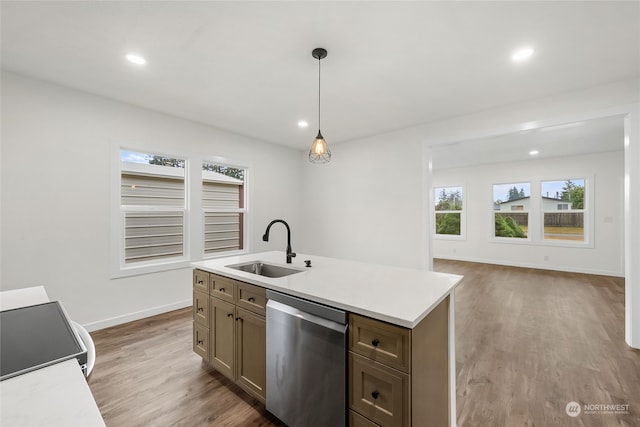 kitchen with pendant lighting, stove, sink, stainless steel dishwasher, and hardwood / wood-style flooring