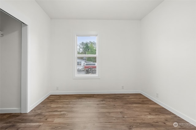 unfurnished room featuring dark hardwood / wood-style flooring